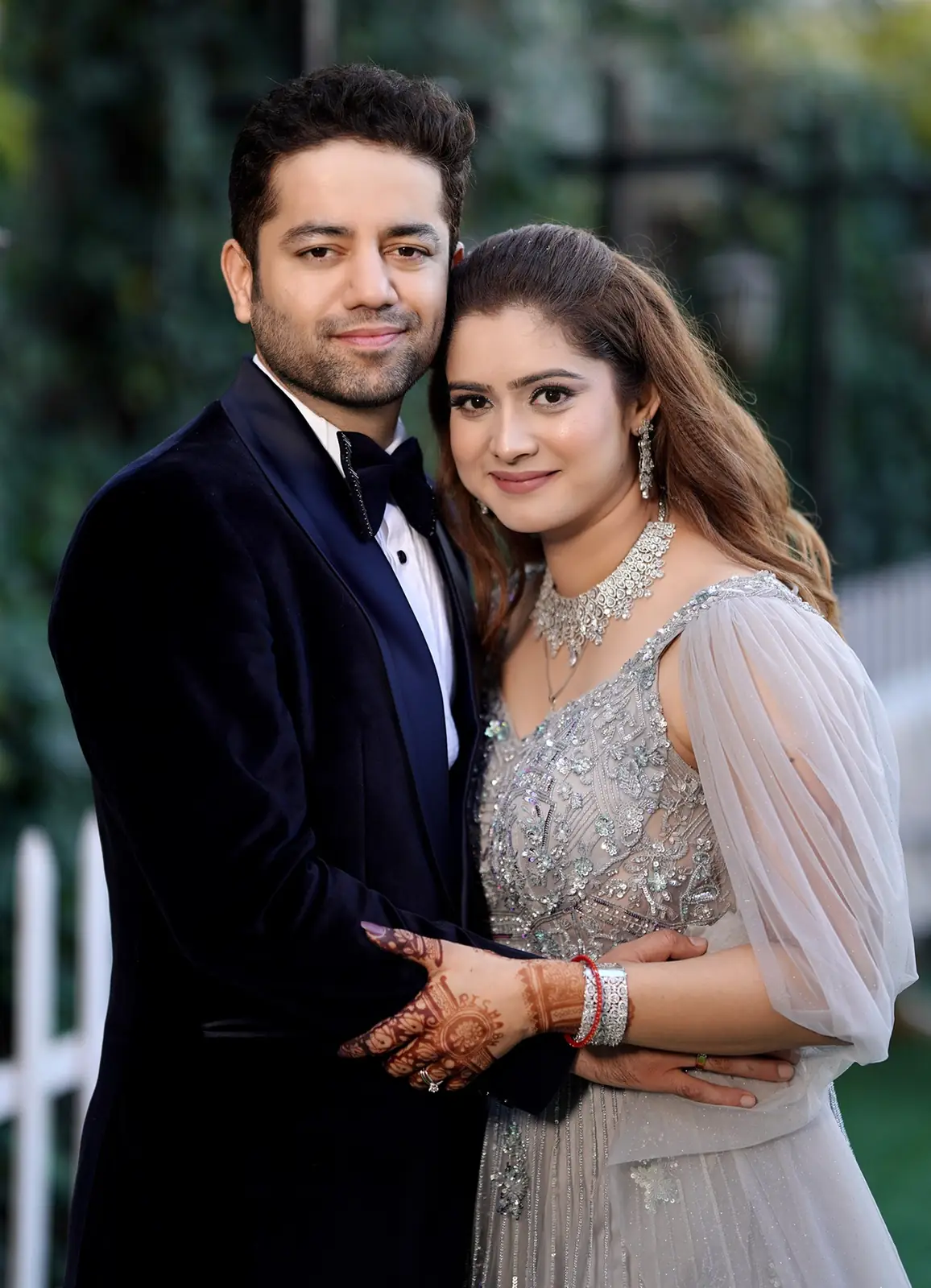 Close-up engagement photo of couple smiling.