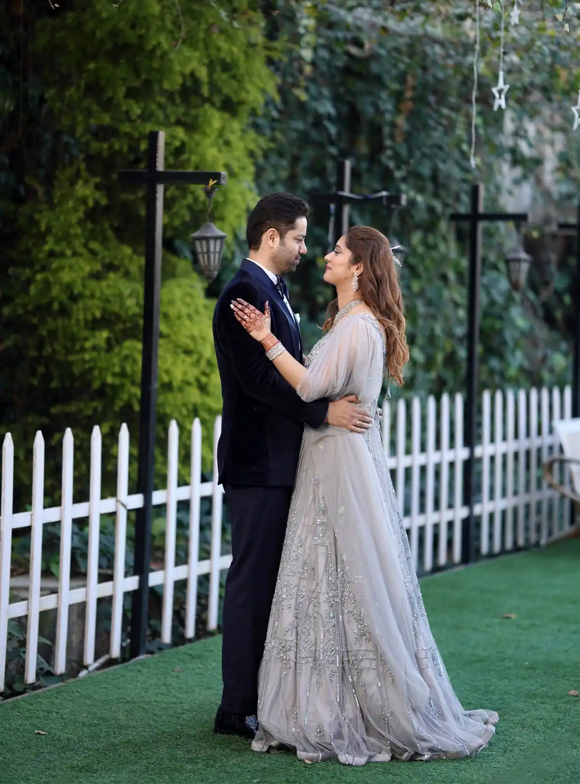 Engagement couple posing together in an elegant outdoor photoshoot